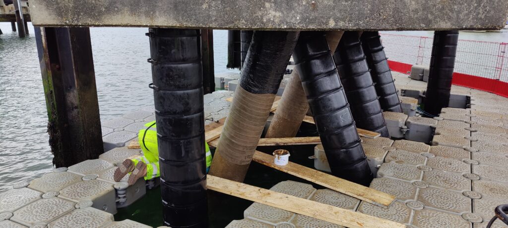 Petrolatum Tape being wrapped to a pile on Lymington Jetty